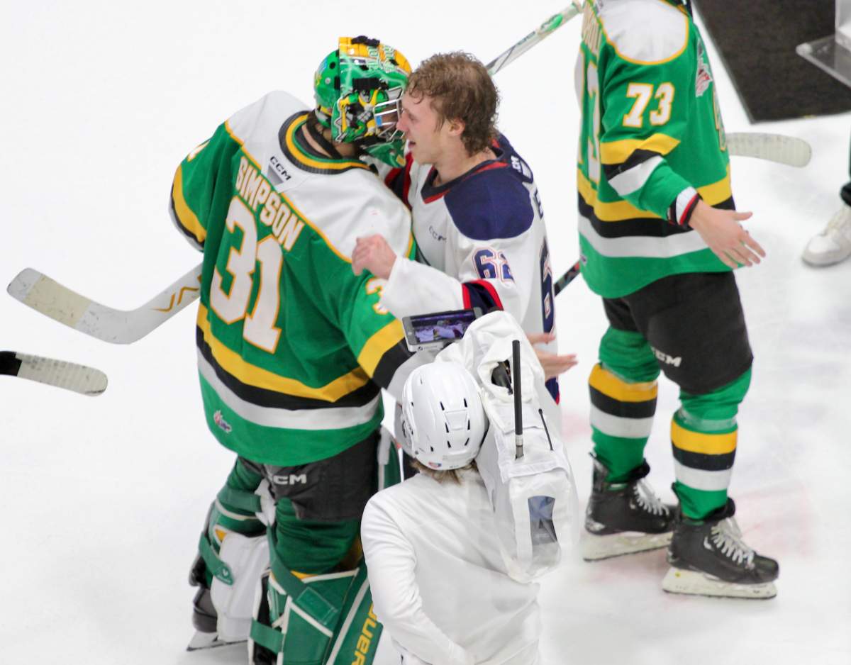 London Knights goaltender Michael Simpson embraces former teammate and Saginaw Spirit forward Owen Beck in the handshake line following the championship game of the 2024 Memorial Cup.