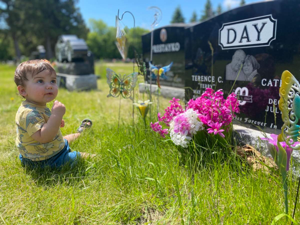 Eleven-month-old Gus sits beside his great-grandparents’ grave. He was able to meet his great-grandmother, Catherine Day, when he was just three days old while she was in hospital after the crash.