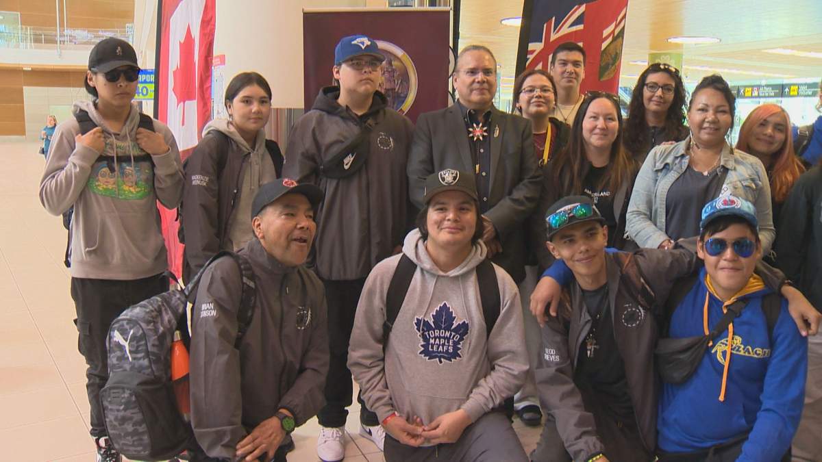 A group of First Nation students pose after returning to Winnipeg