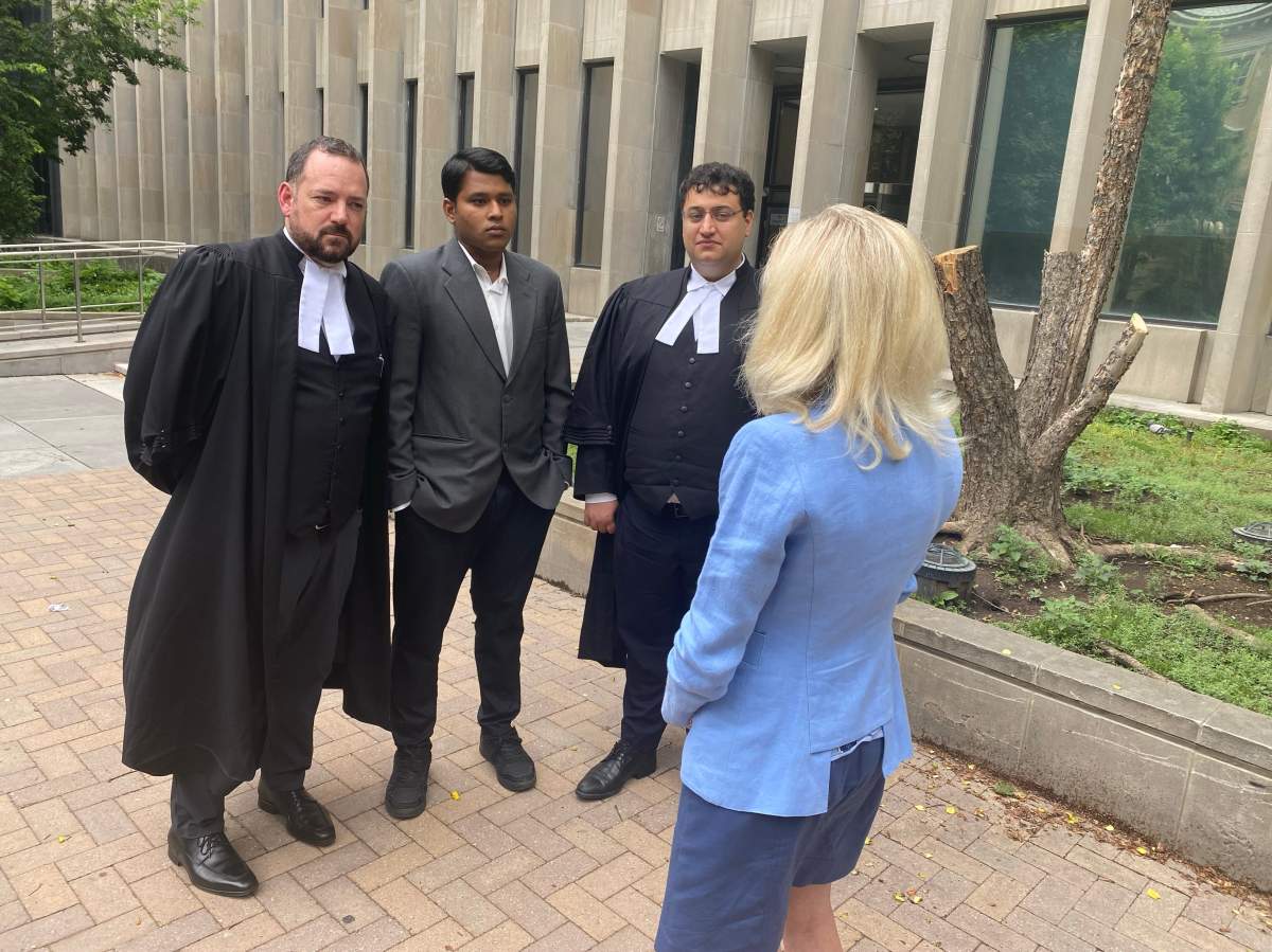 Ahmed Rafin (centre) talks to Global News’ Catherine McDonald with his lawyers.