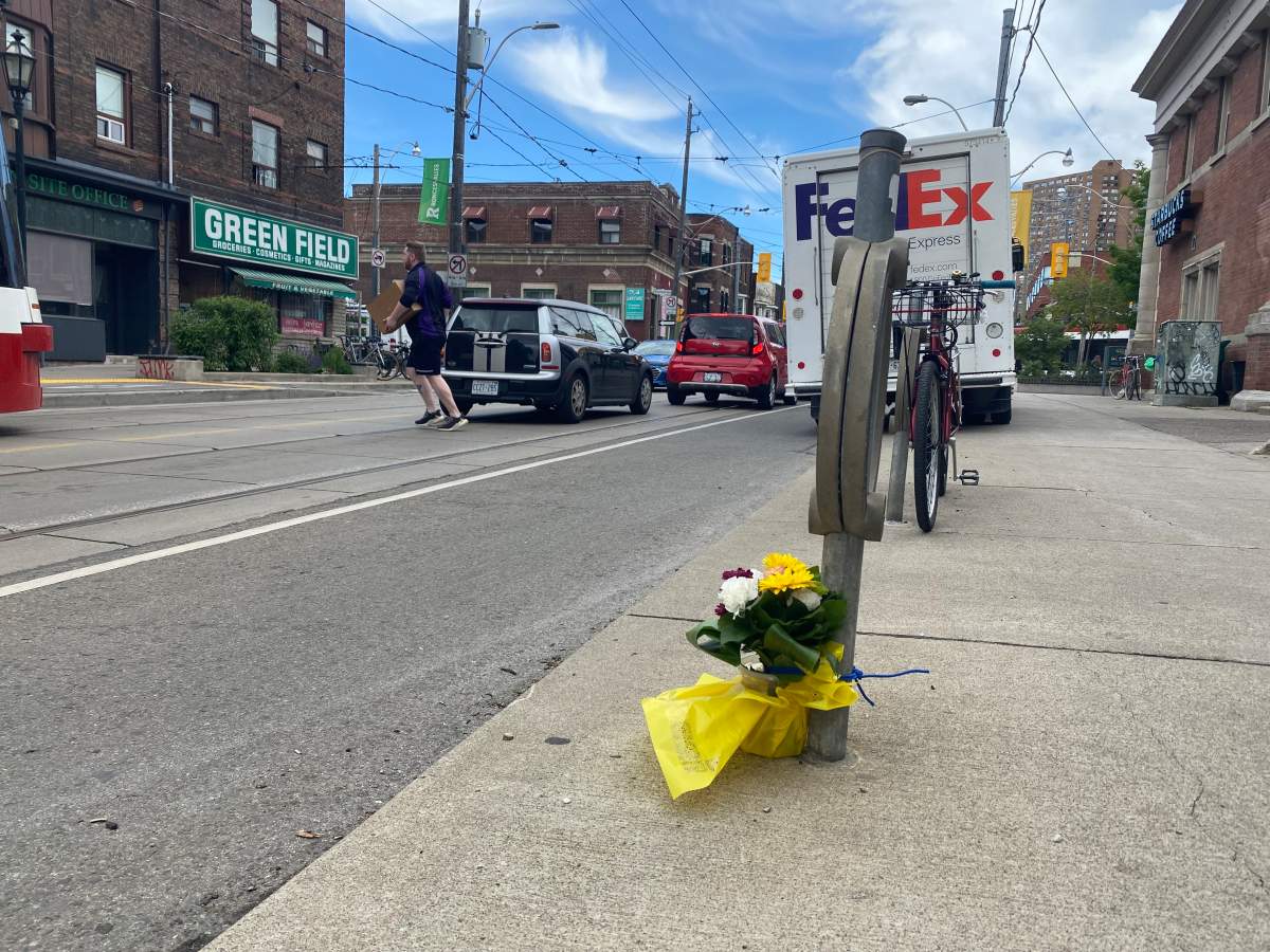 Flowers are laid at the intersection where a man was struck and killed by a vehicle in Toronto on June 6, 2024.