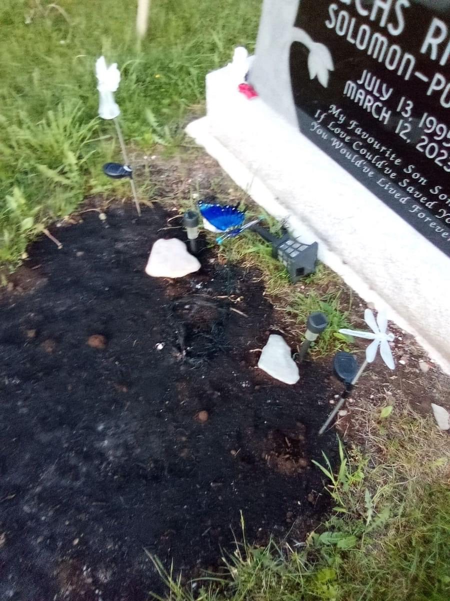 A blurry picture provided to Global from Lucas Solomon-Polchies’ sister, Kayla Solomon, taken of the burned grave shows the land in front of the plot completely burned and turned black.