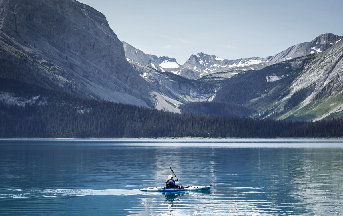 A kayaker paddles across Upper Kananaskis Lake in Kananaskis, Alta., Monday, July 3, 2023.