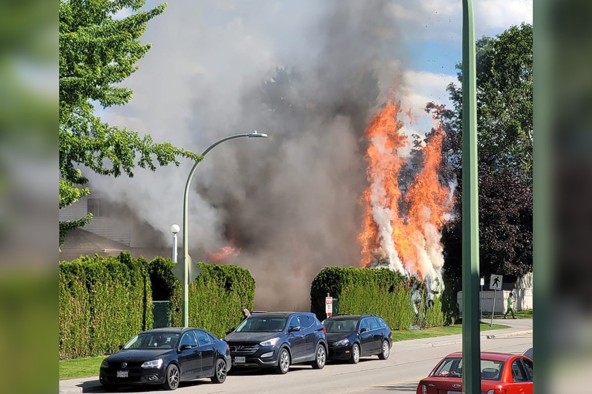 Flames and smoke rise from a townhome fire in Kelowna’s Rutland neighbourhood on Friday afternoon.