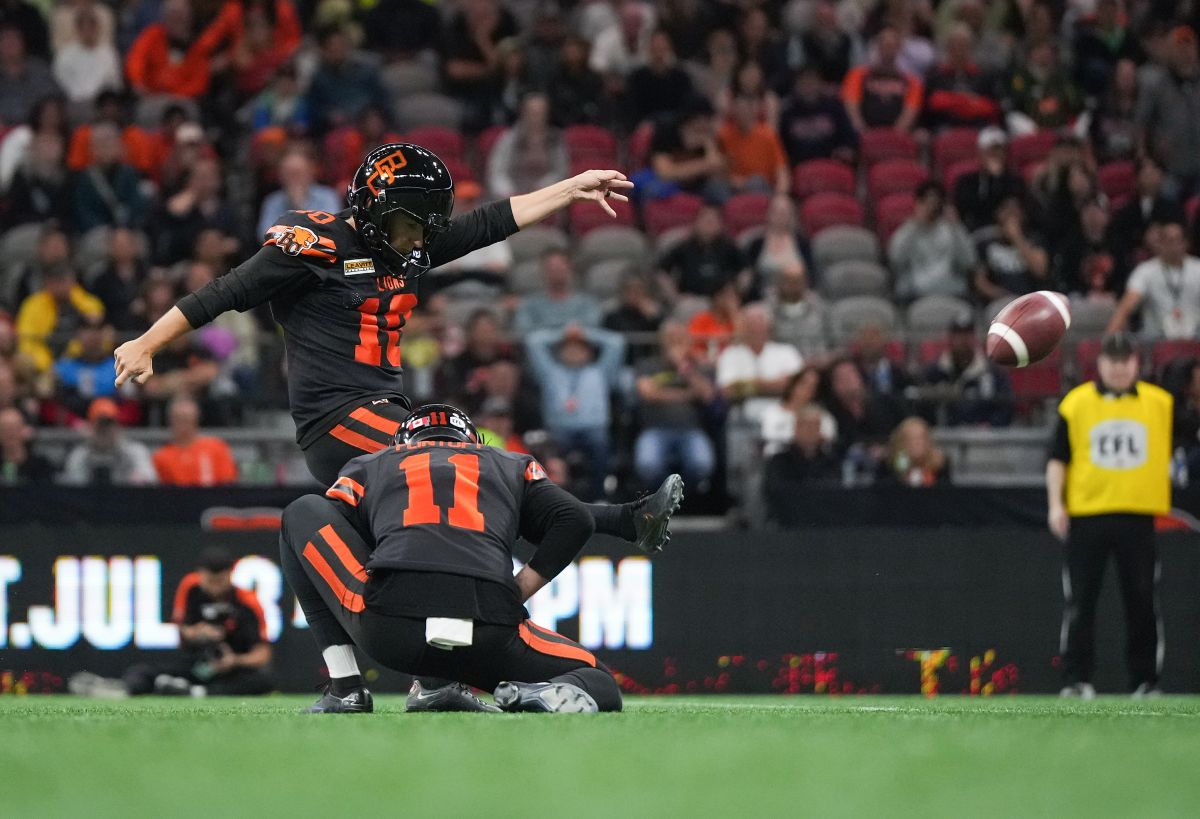 B.C. Lions' Sean Whyte kicks the winning field goal with no time left on the clock as Stefan Flintoft holds during the second half of a CFL football game against the Edmonton Elks, in Vancouver, on Thursday, June 27, 2024.