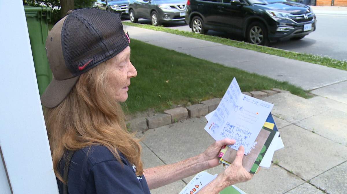 Woman holds hand-written cards