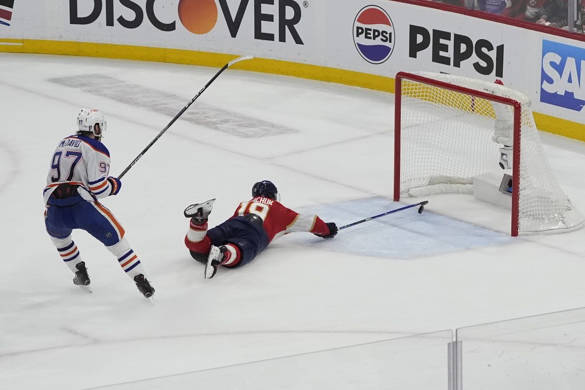 Florida Panthers left wing Matthew Tkachuk (19) attempts to stop a goal by Edmonton Oilers center Connor McDavid (97) during the third period of Game 5 of the NHL hockey Stanley Cup Finals, Tuesday, June 18, 2024, in Sunrise, Fla. The Oilers defeated the Panthers 5-3.