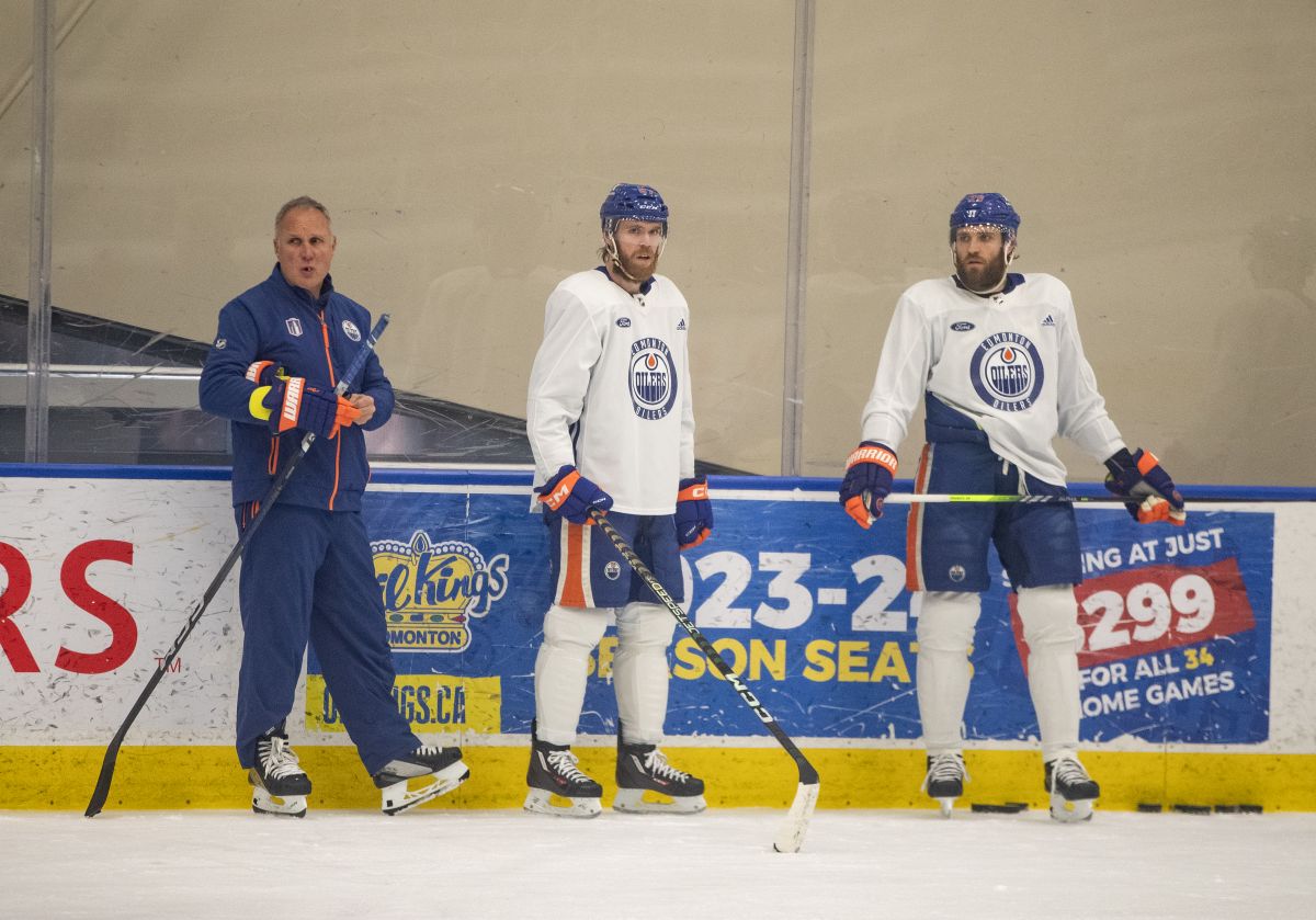 Edmonton Oilers' defensive coach Paul Coffey stands with Connor McDavid (97) and Leon Draisaitl (29) during practice in Edmonton on Thursday June 20, 2024. The Edmonton Oilers take on the Florida Panthers in game 6 of the NHL Stanley Cup final on Friday.