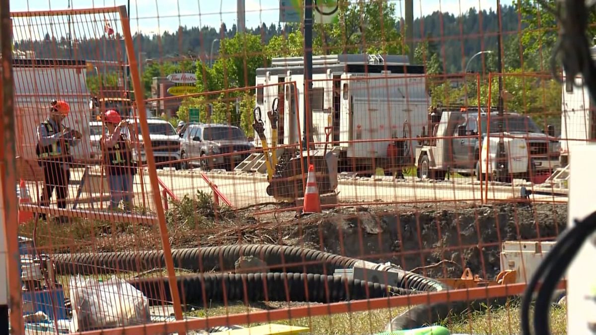 Occupational Health and Safety personnel seen at the site of a broken feeder main in Calgary on June 13, 2024. The night before, two workers were injured while working at the site.