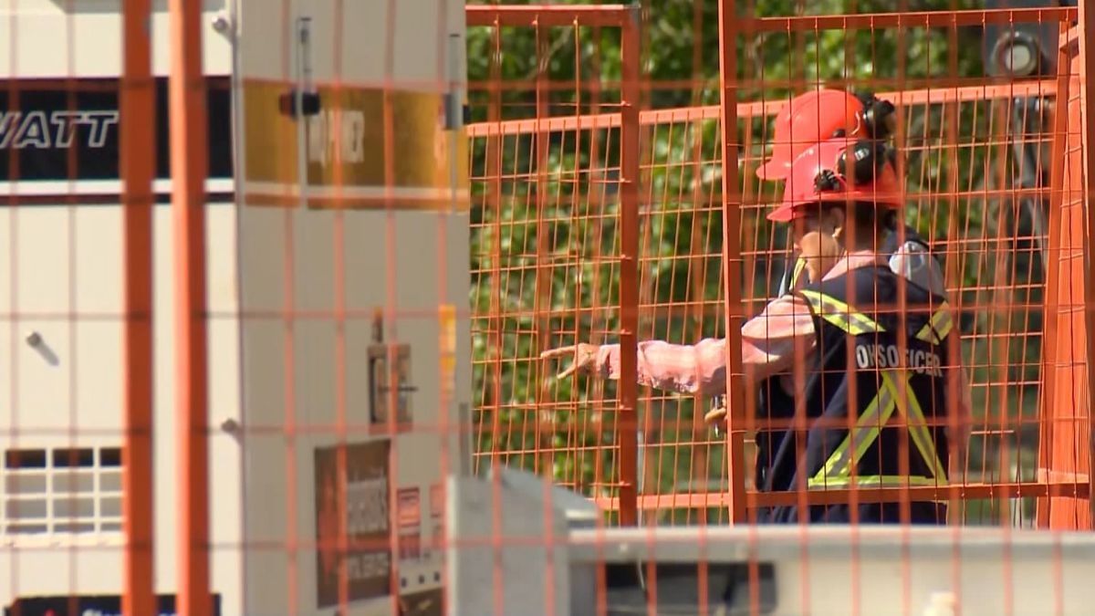 Occupational Health and Safety personnel seen at the site of a broken feeder main in Calgary on June 13, 2024. The night before, two workers were injured while working at the site.