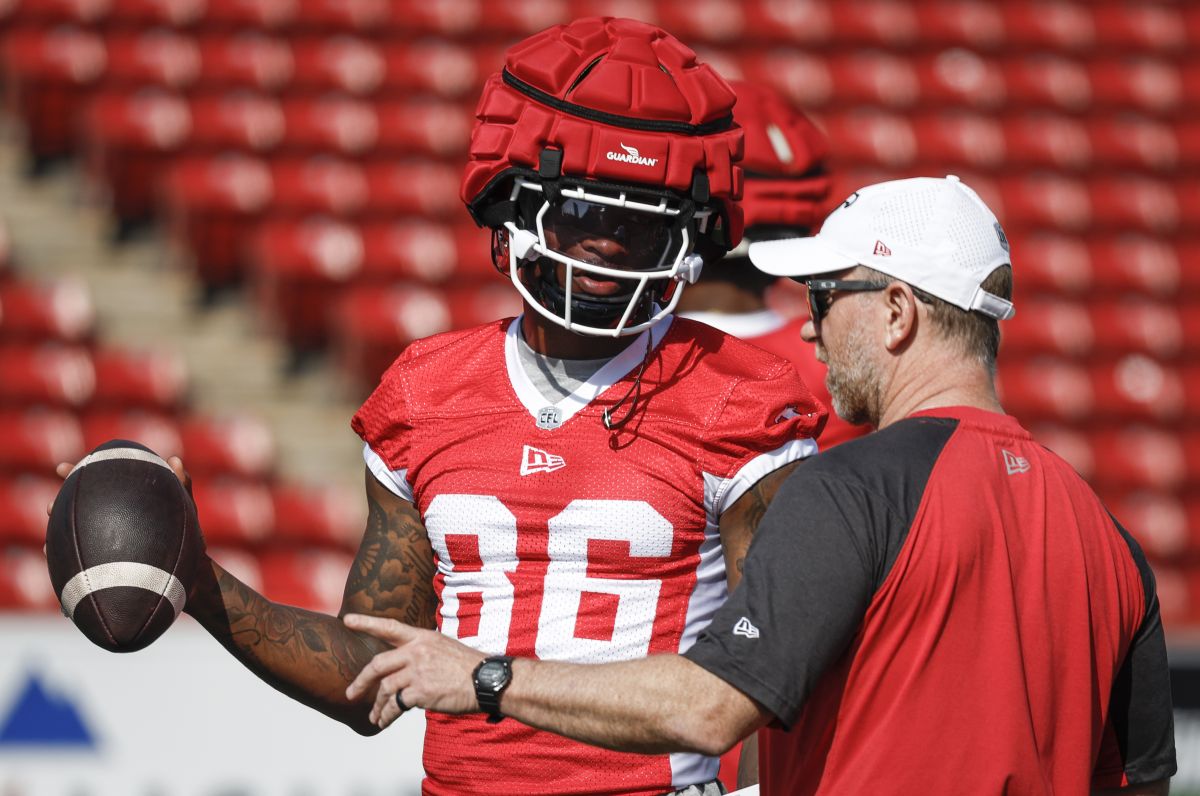 Calgary Stampeders wide receiver Tre Odoms-Dukes, left, chats with head coach Dave Dickenson during opening day of training camp in Calgary, Alta., Sunday, May 12, 2024.