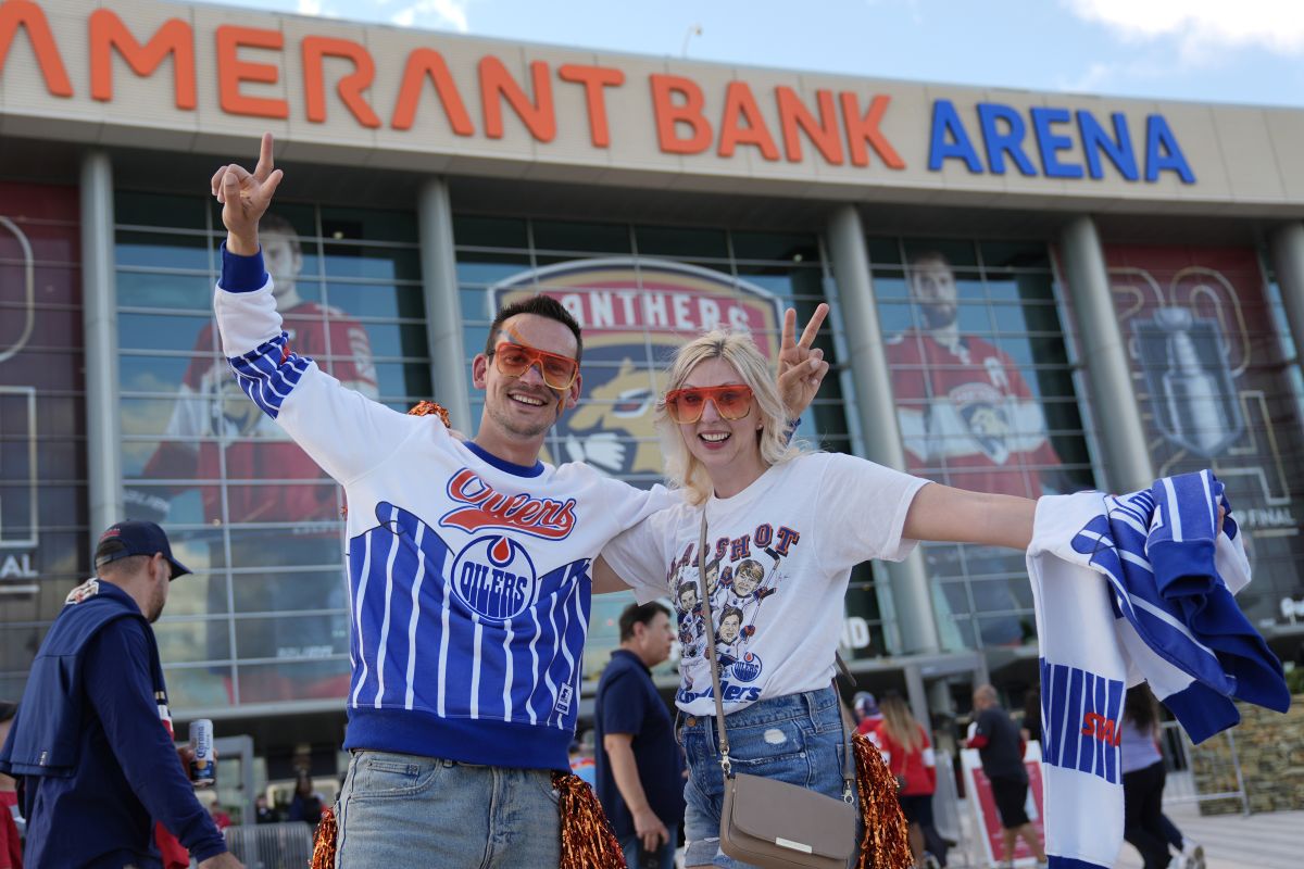Richard Haas and Alyssa Dudek of Edmonton wait to enter the Amerant Bank Arena before Game 5 of the NHL hockey Stanley Cup Finals between the Florida Panthers and the Edmonton Oilers, Tuesday, June 18, 2024, in Sunrise, Fla.