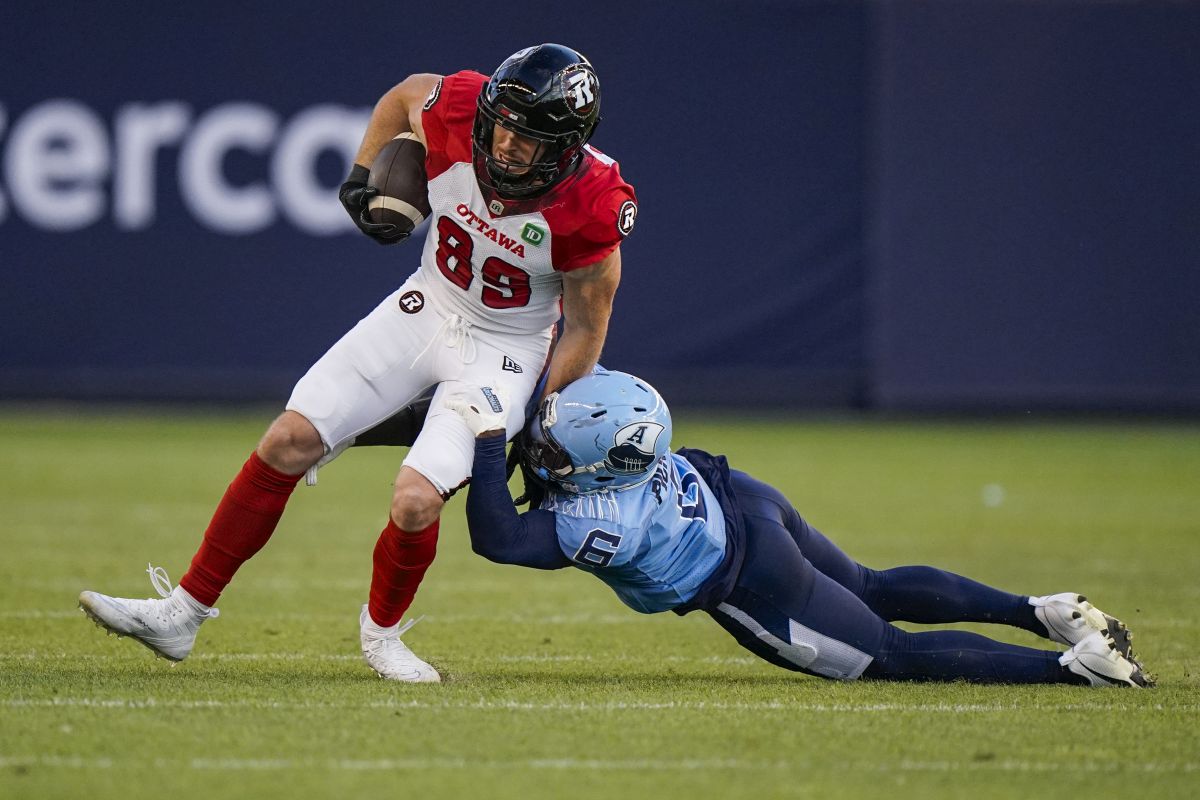 Ottawa Redblacks fullback Marco Dubois (89) is tackled by Toronto Argonauts defensive back Adarius Pickett (6) during first half CFL football action in Toronto, on Sunday, August 13, 2023.