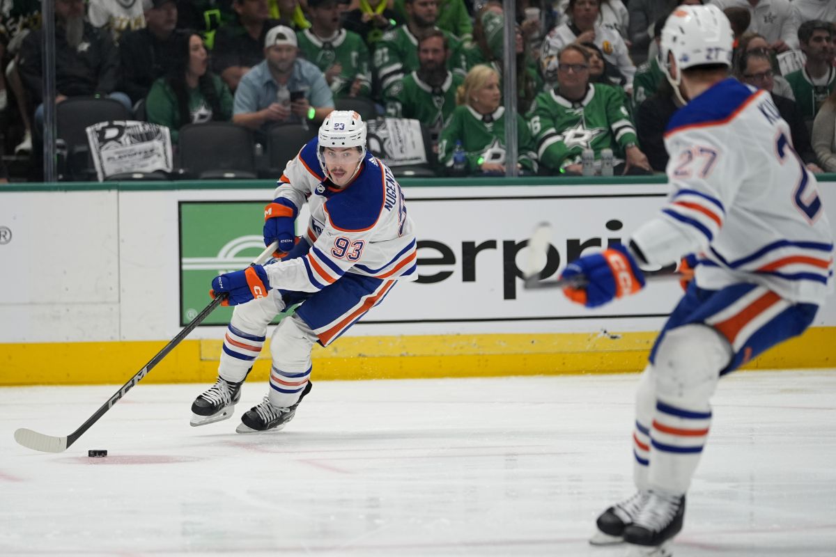Edmonton Oilers centre Ryan Nugent-Hopkins (93) handles the puck in front of defenceman Brett Kulak (27) during the first period in Game 5 of the Western Conference finals in the NHL hockey Stanley Cup playoffs against the Dallas Stars Friday, May 31, 2024, in Dallas.