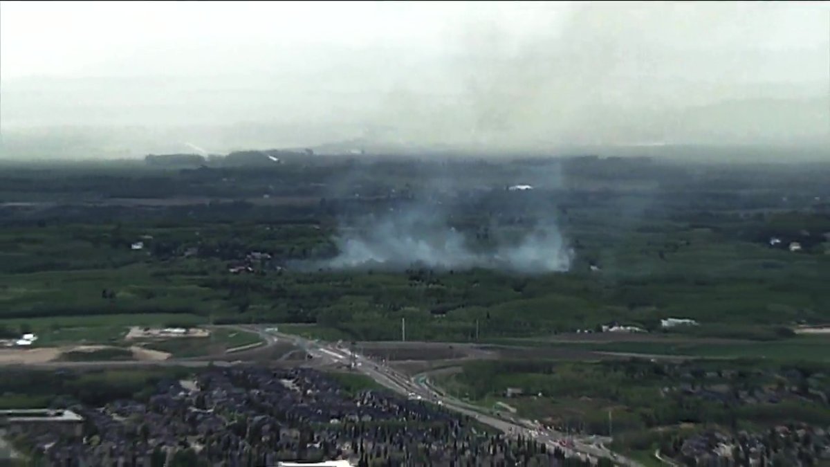 A grassfire west of Calgary burning near Highway 1. Crews from Rocky View County were called into help.