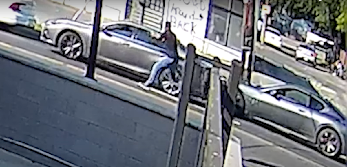 Screengrab of surveillance footage provided by D.C. police showing the moment a Maserati driver opened fire into a car that cut him off in traffic.
