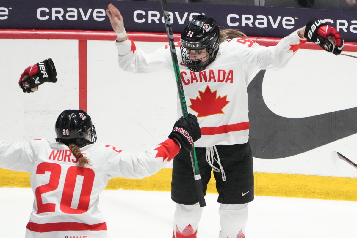 Canada's Danielle Serdachny (92) celebrates her overtime goal with teammate Sarah Nurse (20) in their gold medal game against the United States at the IIHF Women's World Hockey Championship in Utica, N.Y., Sunday, April 14, 2024.