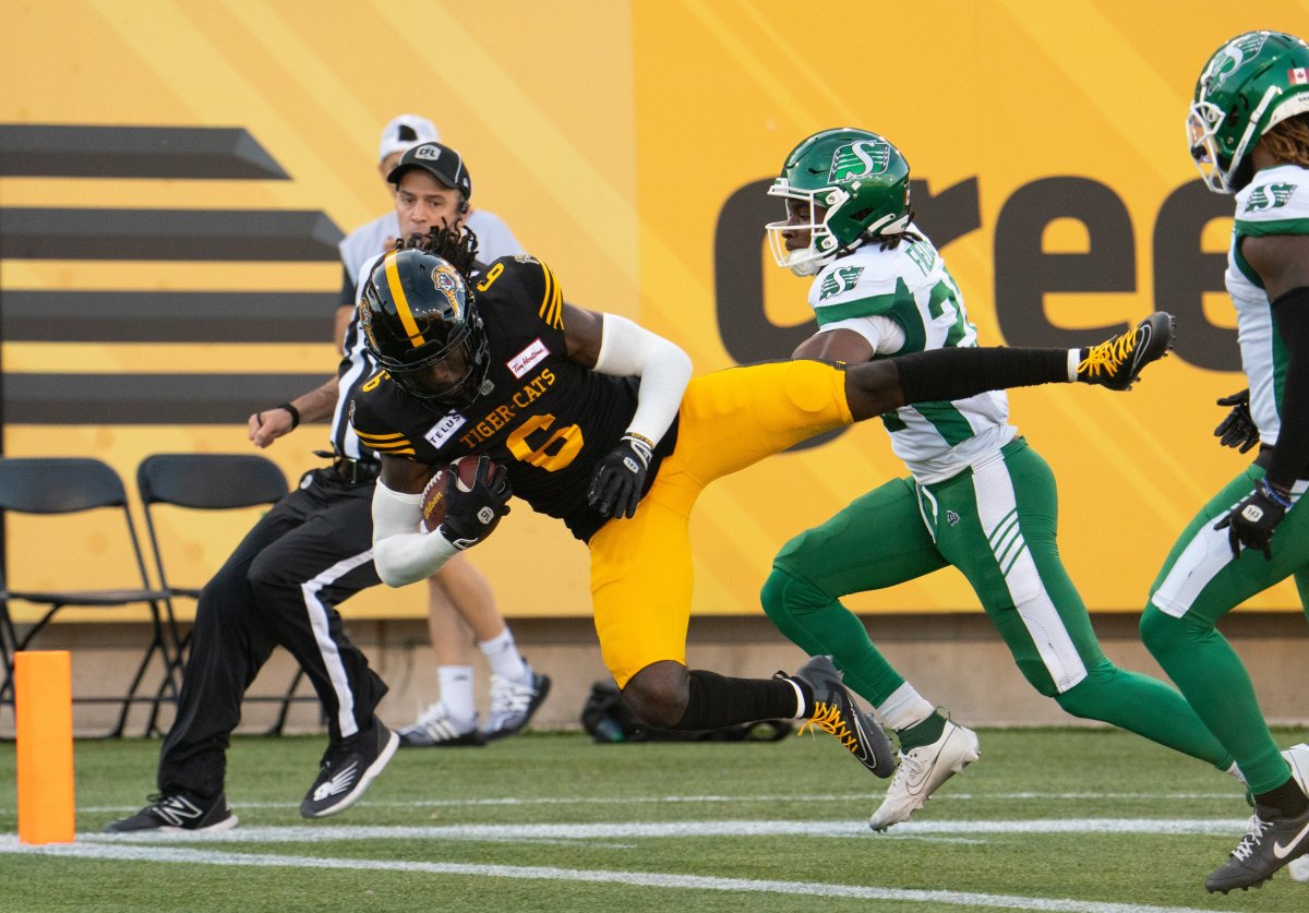 Hamilton Tiger Cats wide receiver Steven Dunbar Jr. (6) leaps over the goal line for a touchdown against the Saskatchewan Roughriders during first half CFL football action in Hamilton, Ont., Sunday, June 16, 2024.