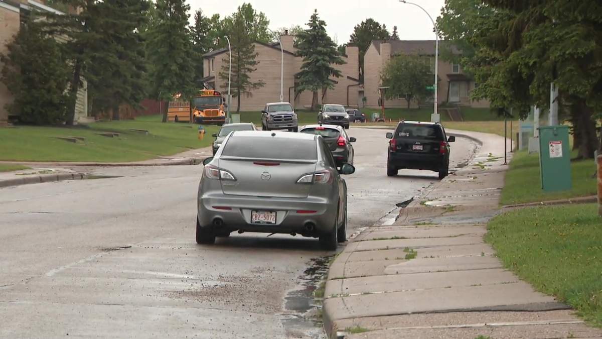 Vehicles parked on the street outside a condo complex in northwest Edmonton's Dunluce neighbourhood on Wednesday, June 12, 2024.
