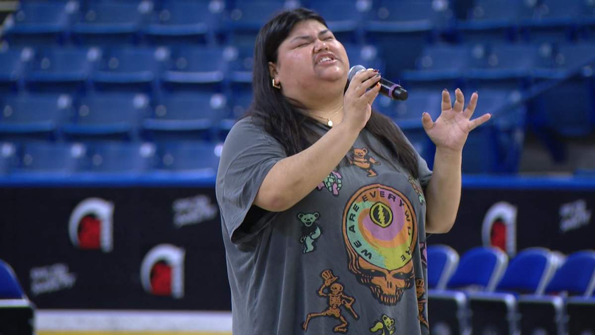 Rebecca Strong singing during a sound check before a Saskatchewan Rattlers game.
