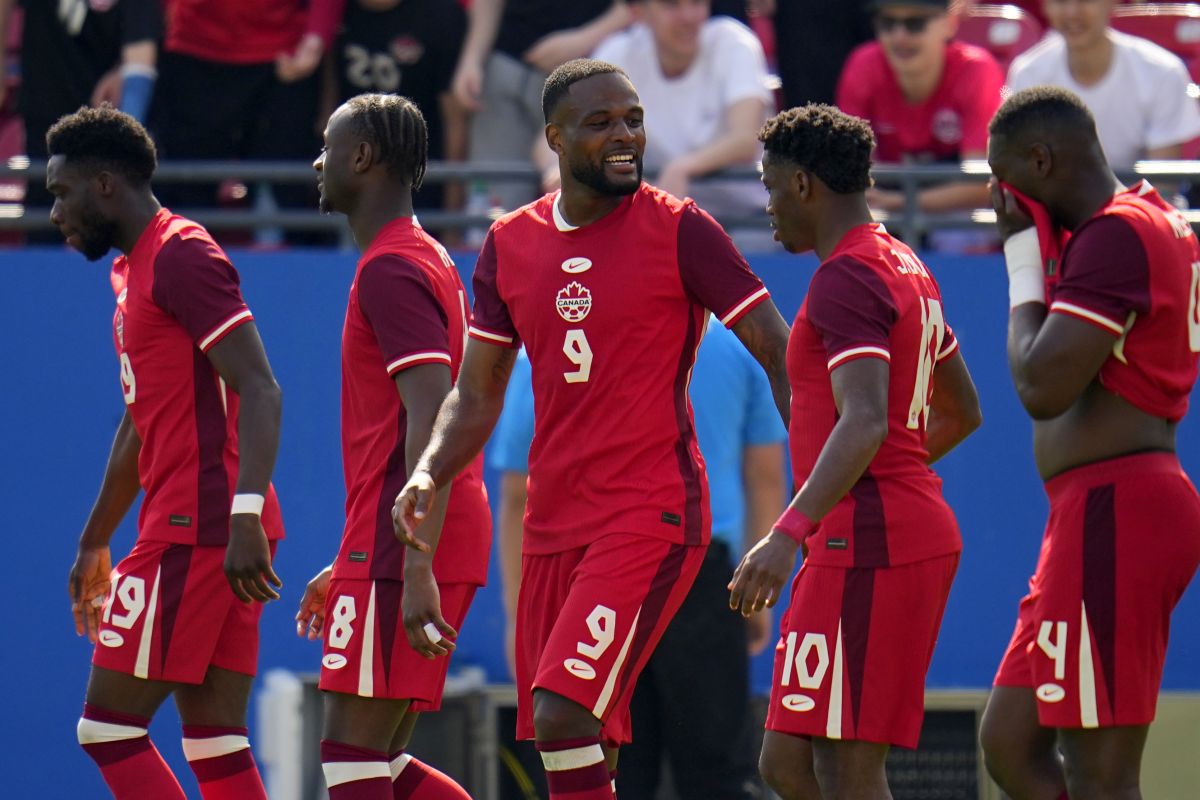 Canada's Alphonso Davies (19), Ismael Kone (8), Cyle Larin (9), Jonathan David (10) and Kamal Miller (4) celebrate after Larin scored in the second half of a CONCACAF Nations League Play-In soccer match against Trinidad And Tobago, Saturday, March 23, 2024, in Frisco, Texas.