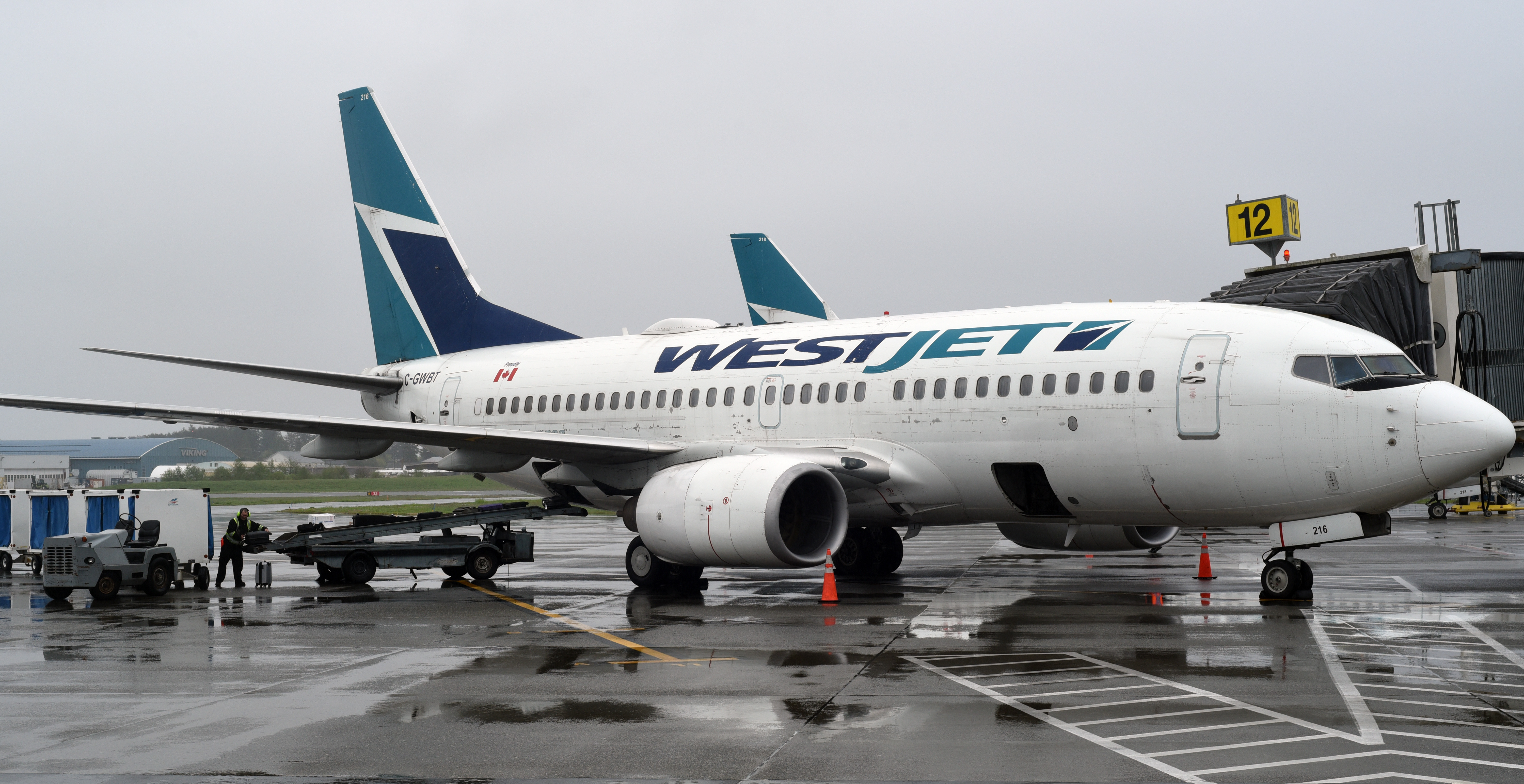 Luggage is pictured being unloaded from a WestJet Boeing 737 NG at Victoria International Airport in Sidney, British Columbia on April 24, 2024.
