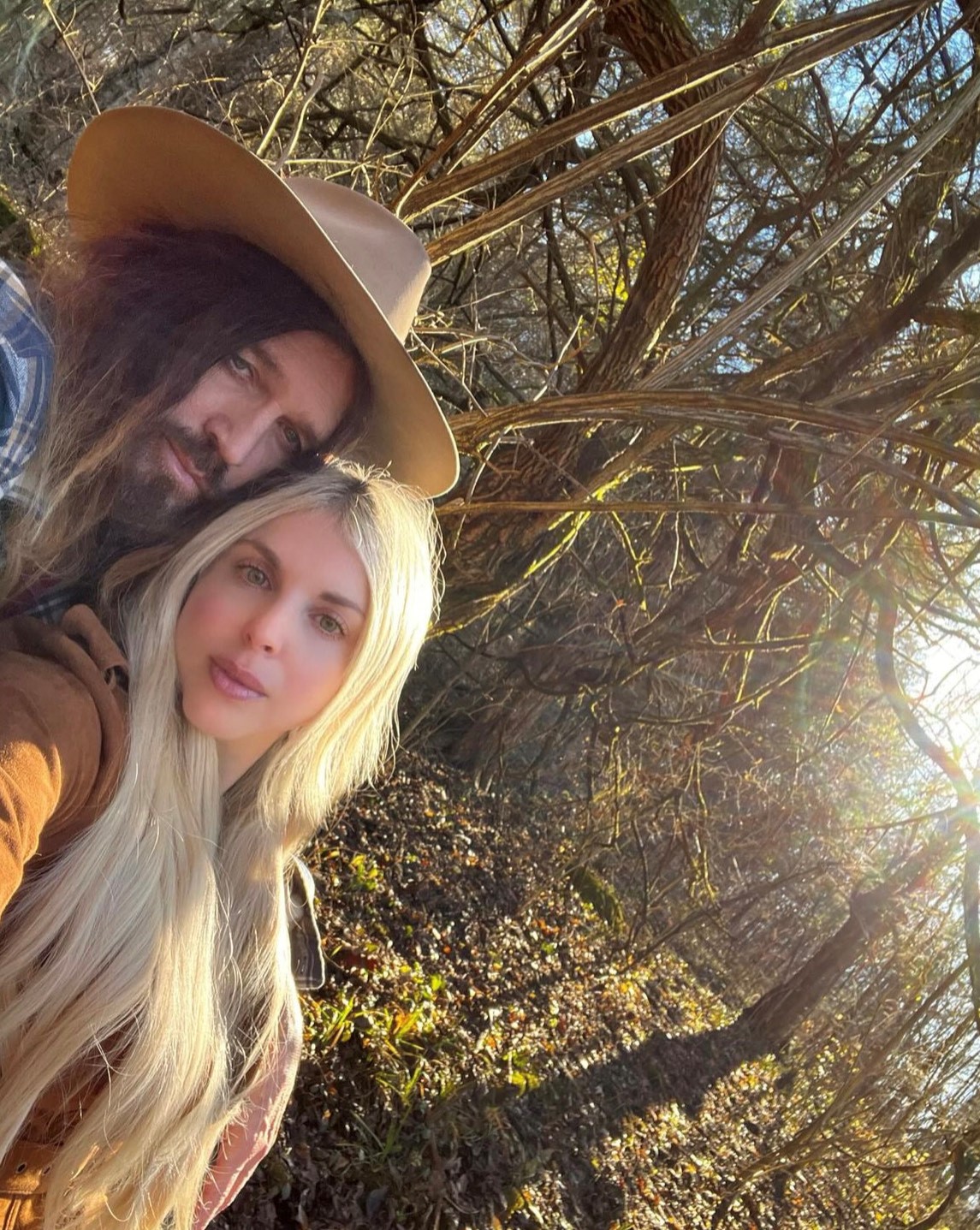 Billy Ray Cyrus and Firerose posing for a selfie.
