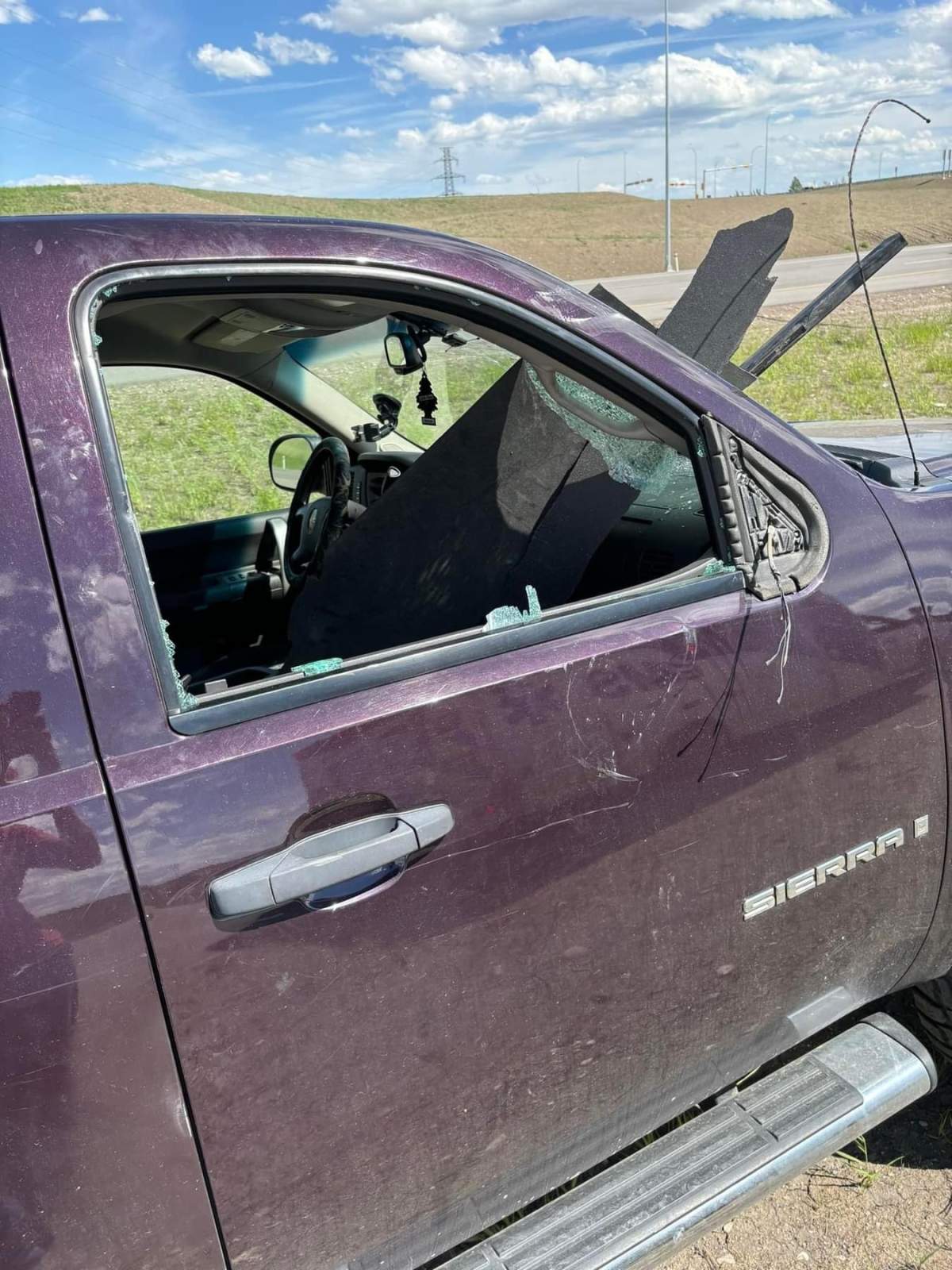 Damage to Nathaniel Dykxhoorn’s vehicle after the tonneau cover from a pickup truck flew off and pierced his windshield.