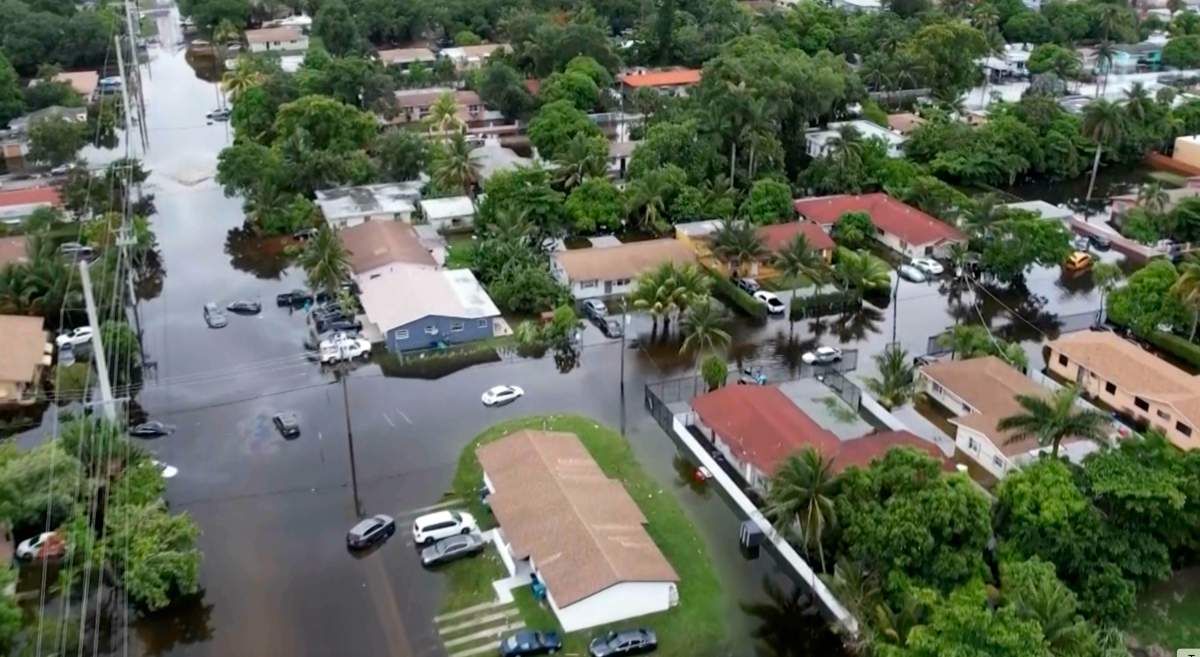 This arial view taken from video shows a flooded street in Northeast Miami-Dade County on Thursday, June 13, 2024. A tropical disturbance brought a rare flash flood emergency to much of southern Florida the day before. Floridians prepared to weather more heavy rainfall on Thursday and Friday. (AP Photo/Daniel Kozin)