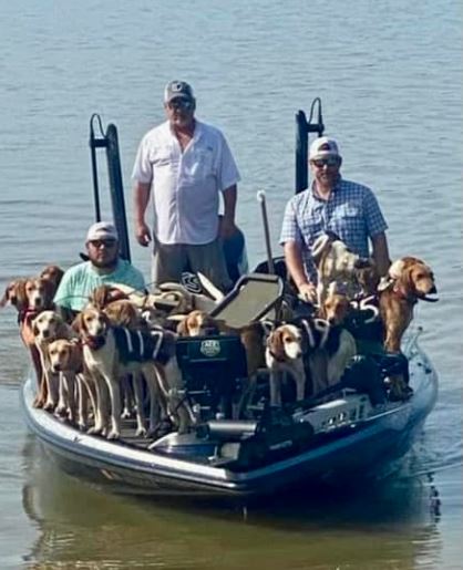 The trio brings a boat full of dogs to the shore of Grenada Lake.