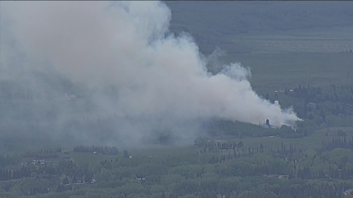 Cochrane RCMP officers and Calgary Fire Department crews are responding to an out-of-control grass fire in Rocky View County on Thursday evening.