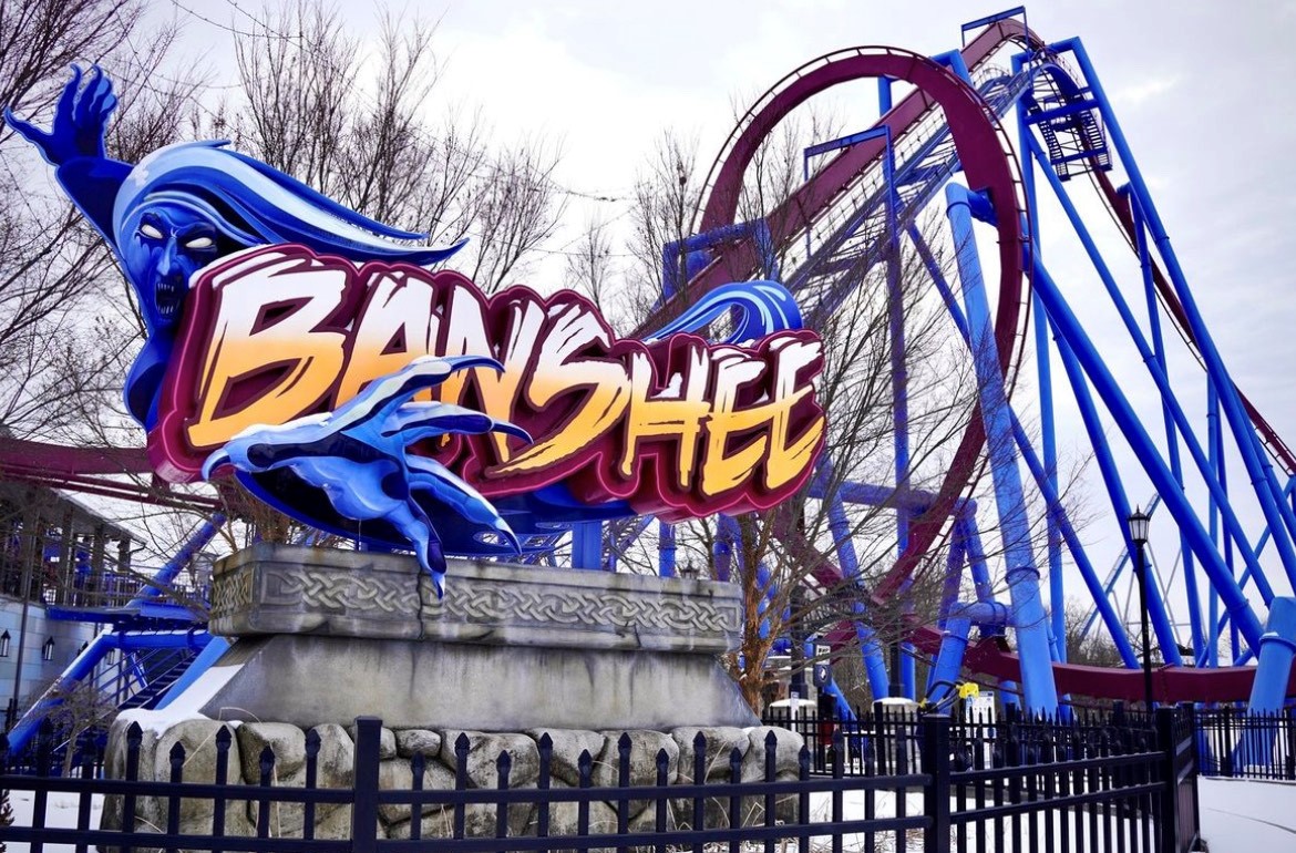 The Banshee roller coaster. It is blue and red, with a visible loop.
