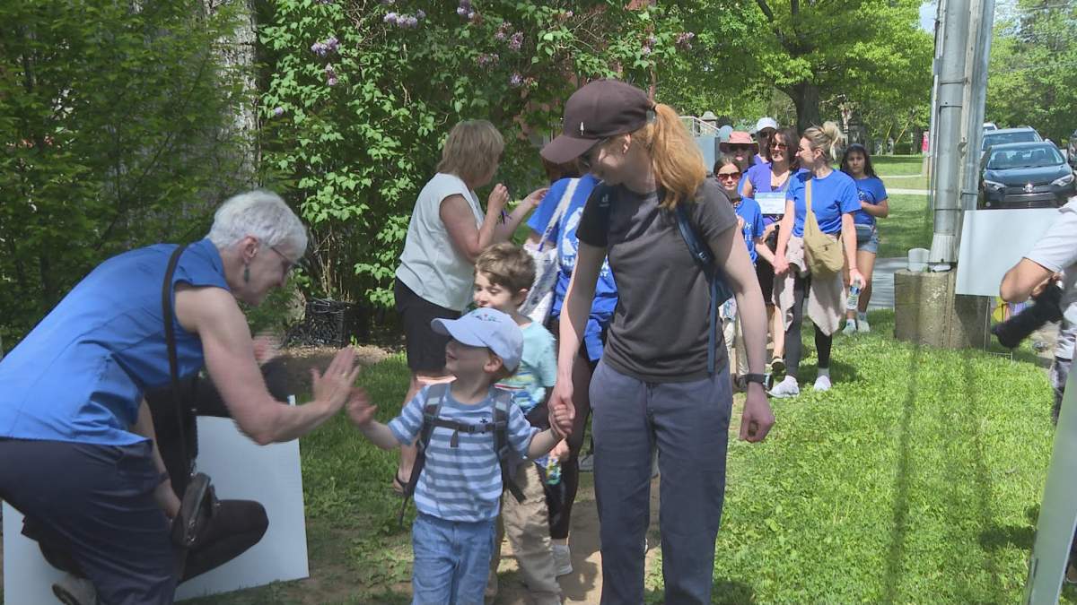 Hikers are met by a cheer squad outside the Hospice Halifax headquarters on Francklyn Street.