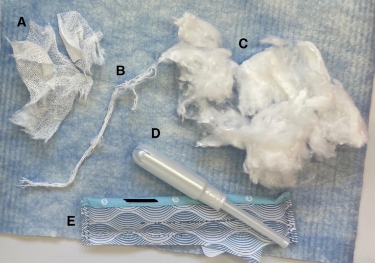 A tampon is separated into its components, including the (A) non-woven outer covering, (B) withdrawal string, (C) inner absorbent core, (D) applicator and (E) wrapper.