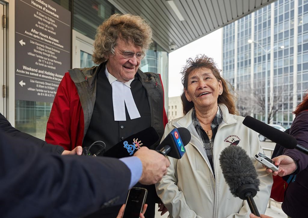 A Manitoba man convicted of murder 50 years ago is getting another court date and a chance to clear his name. Lawyer James Lockyer, left, and Clarence Woodhouse's sister Linda Anderson speak to the media in front of the Law Courts about the release hearing for Woodhouse in Winnipeg, Man., Monday, Oct. 23, 2023.