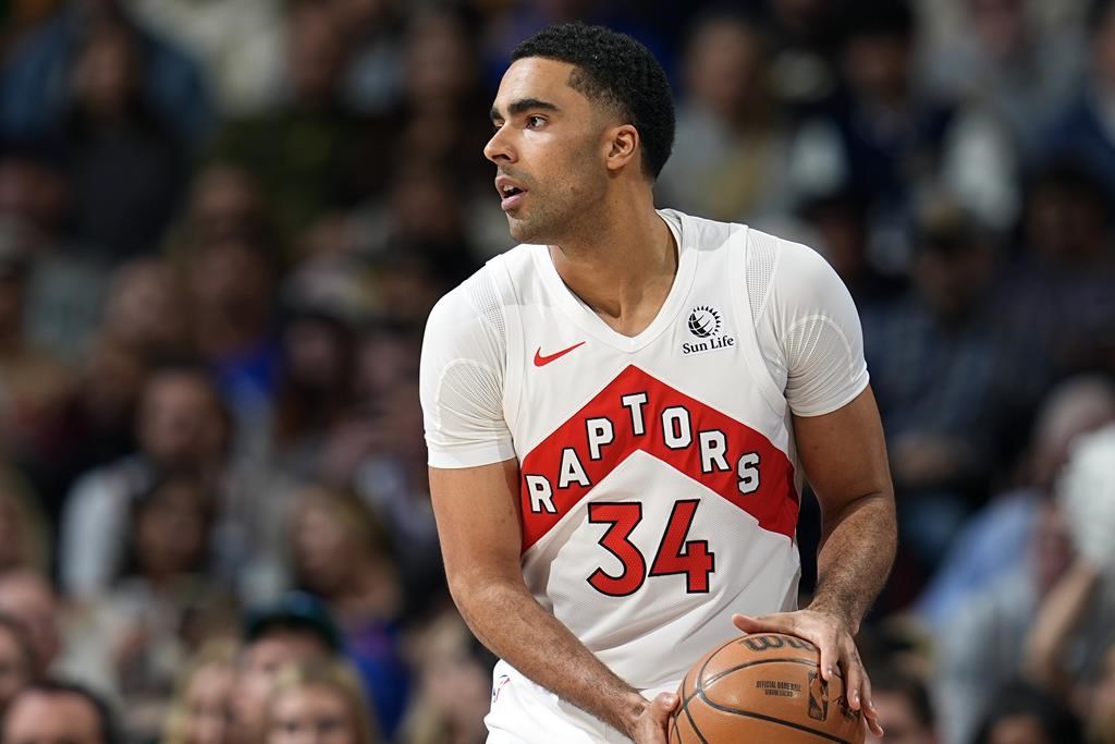 Toronto Raptors center Jontay Porter (34) looks to pass in the first half of an NBA basketball game Monday, March 11, 2024, in Denver. 