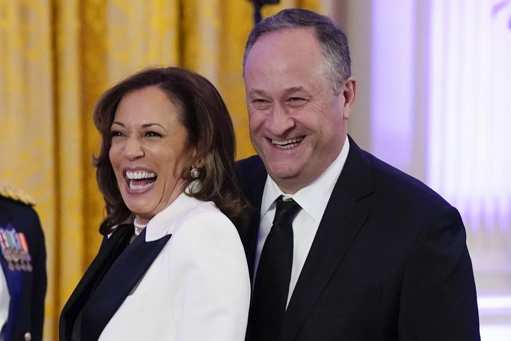 FILE – Vice President Kamala Harris, left, and second gentleman Doug Emhoff arrive in the East Room of the White House, Feb. 11, 2023, in Washington. Emhoff has tested positive for COVID-19 after experiencing mild symptoms, his office announced Sunday, July 7, 2024, but Harris, has tested negative and remains asymptomatic. (AP Photo/Manuel Balce Ceneta, File)