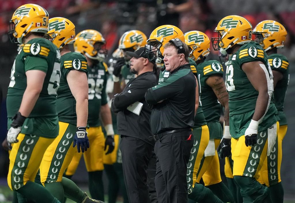 Edmonton Elks head coach Chris Jones, front centre, stands on the sideline during the second half of a preseason CFL football game against the B.C. Lions, in Vancouver, on Friday, May 31, 2024.