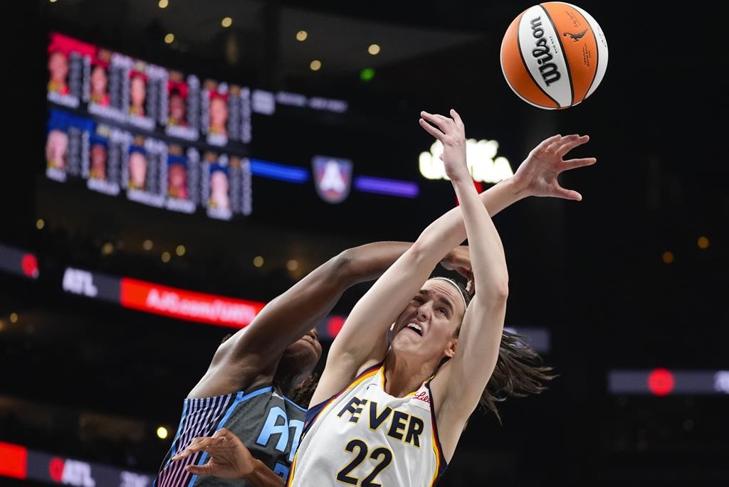 Indiana Fever guard Caitlin Clark (22) battles Atlanta Dream centre Tina Charles (31) for a rebound in the first half of a WNBA basketball game, in Atlanta, Friday, June 21, 2024. THE CANADIAN PRESS/AP-John Bazemore.