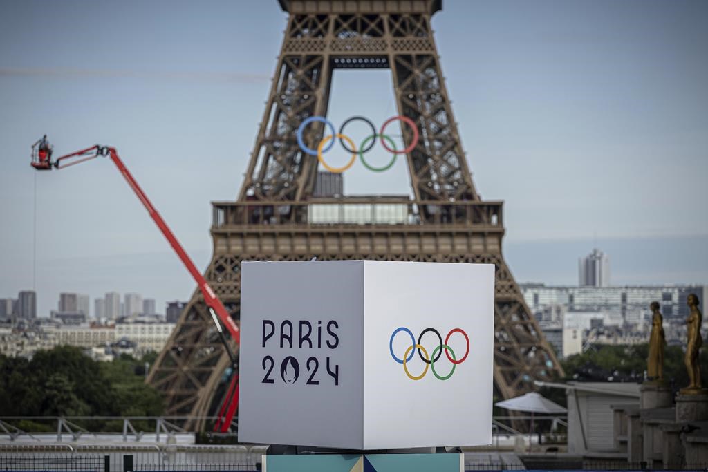 A majority of Canadians will watch this summer’s Paris Olympics in some capacity but only a small percentage will follow closely, according to a new national poll.
Polling firm Leger asked more than 1,500 people about their views of the upcoming Summer Games and their overall perceptions of the Olympics in an online survey conducted between July 12 and 14.The Olympic rings are seen on the Eiffel Tower, Sunday, July 14, 2024, in Paris. THE CANADIAN PRESS/AP/Aurelien Morissard.