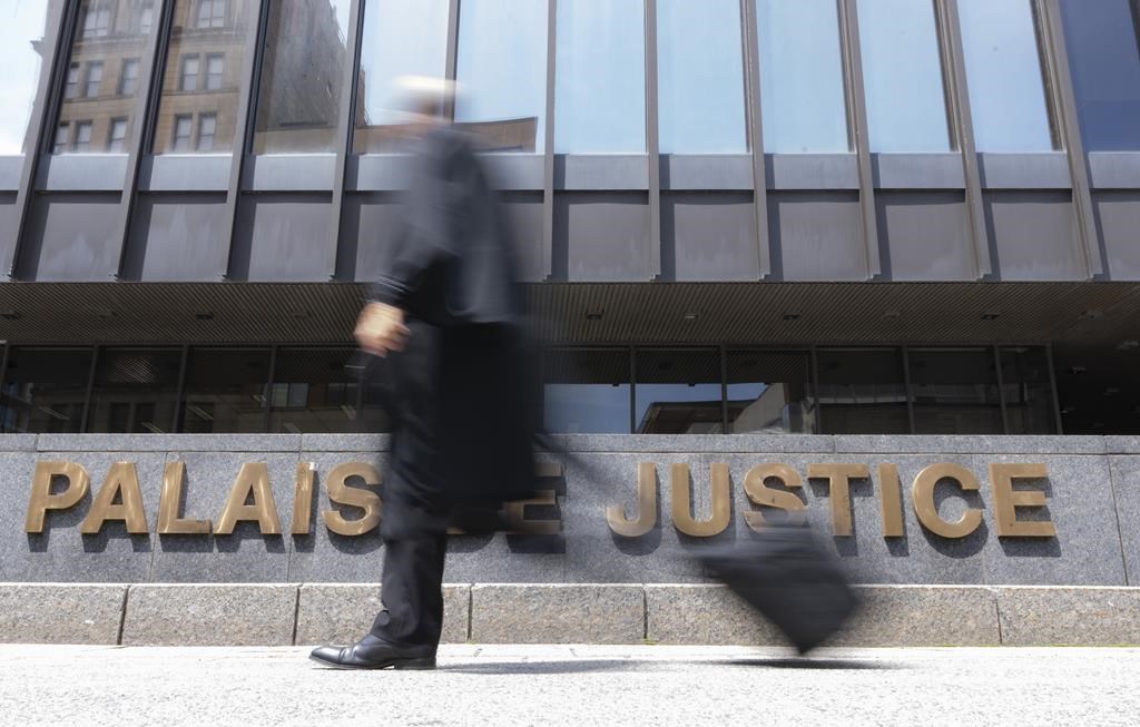 A lawyer walks past the courthouse in Montreal on July 12, 2023. THE CANADIAN PRESS/Christinne Muschi.