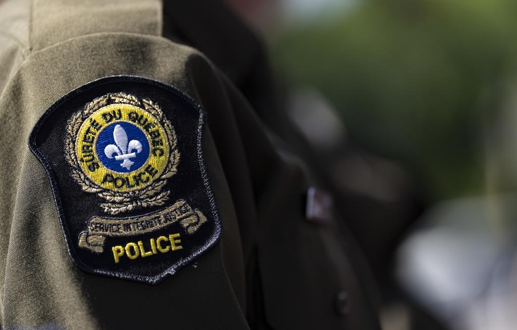 A Surete du Quebec emblem is seen on an officer’s uniform.