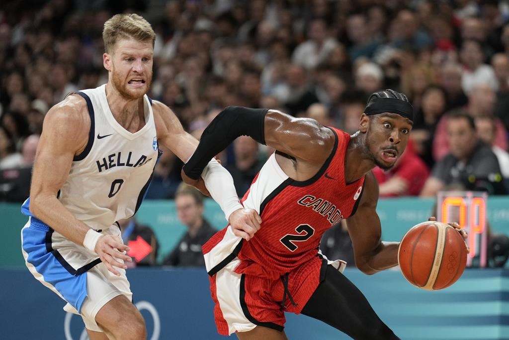 Shai Gilgeous-Alexander, of Canada, drives past Thomas Walkup, of Greece, in a men's basketball game at the 2024 Summer Olympics, Saturday, July 27, 2024 in Villeneuve-d'Ascq, France. (AP Photo/Mark J. Terrill).