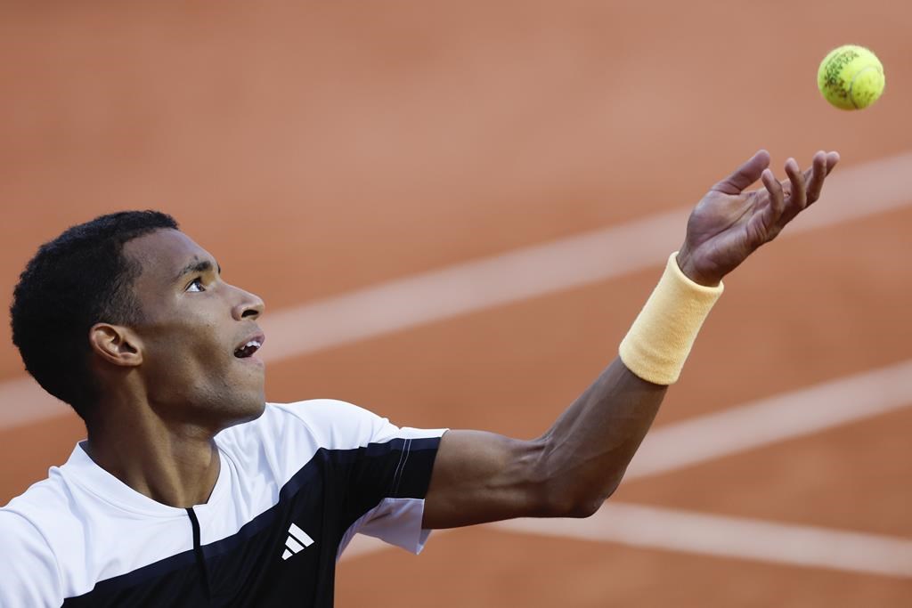 Canada's Felix Auger-Aliassime serves against Ben Shelton of the U.S. during their third round match of the French Open tennis tournament at the Roland Garros stadium in Paris, Friday, May 31, 2024. Auger-Aliassime and Bianca Andreescu started off Sunday’s matches at the Paris Olympics with straight-set victories. THE CANADIAN PRESS/AP/Jean-Francois Badias.