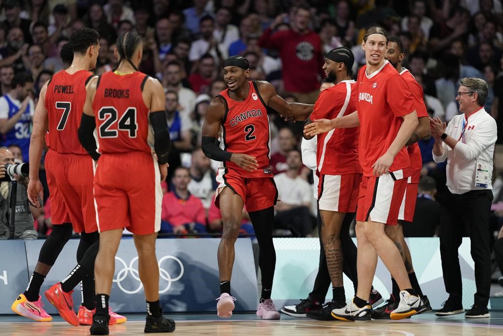 Shai Gilgeous-Alexander, of Canada, celebrates with teammates after scoring and being fouled by Greece in a men's basketball game at the 2024 Summer Olympics, Saturday, July 27, 2024 in Villeneuve-d'Ascq, France. THE CANADIAN PRESS/AP-Mark J. Terrill.