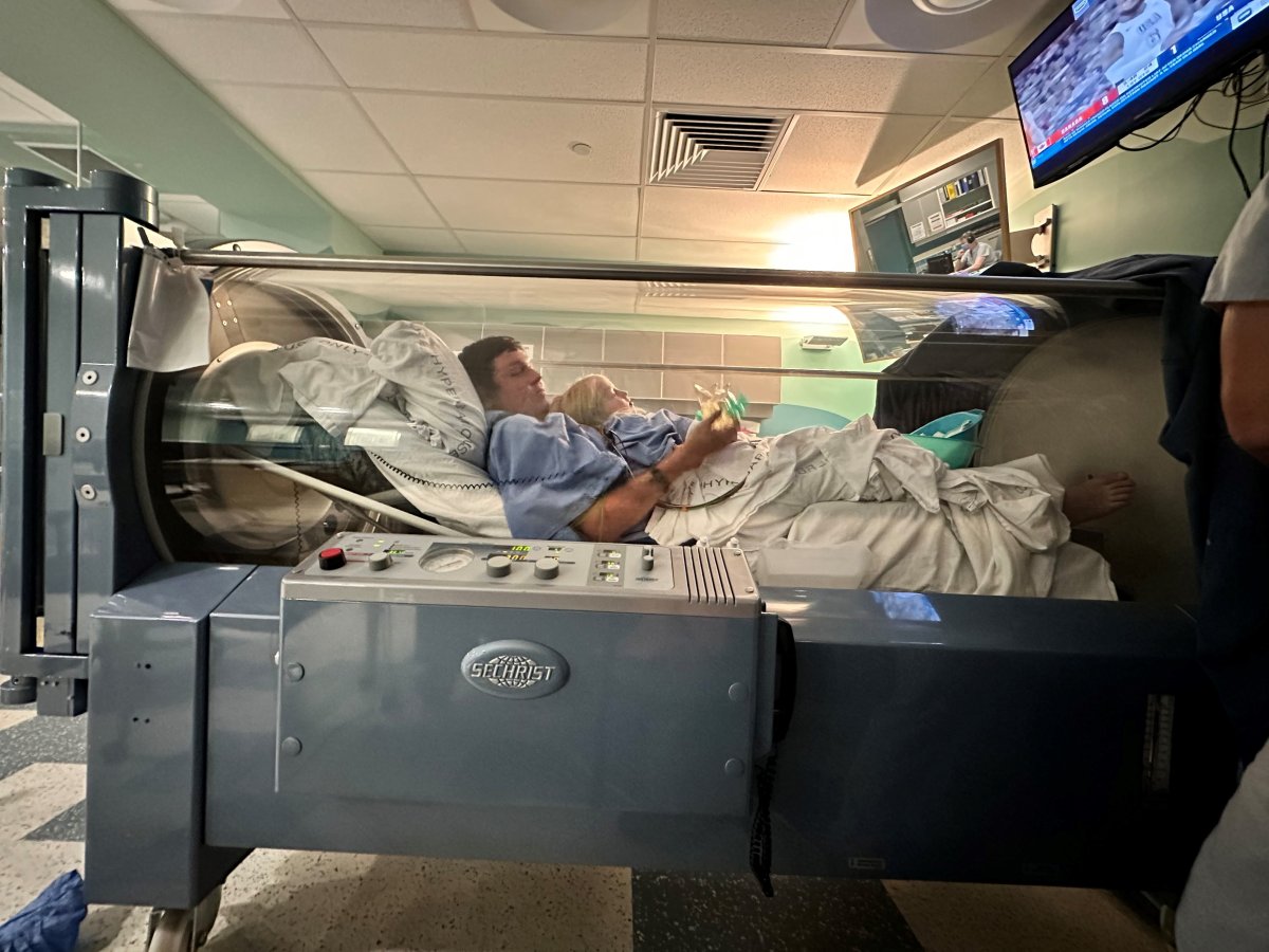 Brandon Roy and six-year-old Valerie inside the hyperbaric oxygen therapy chamber at an Edmonton hospital.