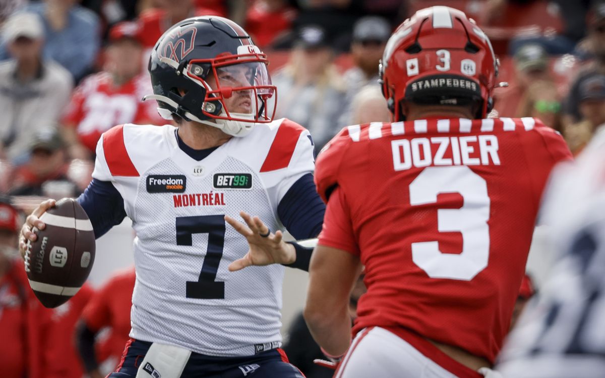 Montreal Alouettes quarterback Cody Fajardo, left, prepares to throw the ball as Calgary Stampeders defensive back Branden Dozier closes in during first half CFL football action in Calgary, Saturday, Sept. 23, 2023.