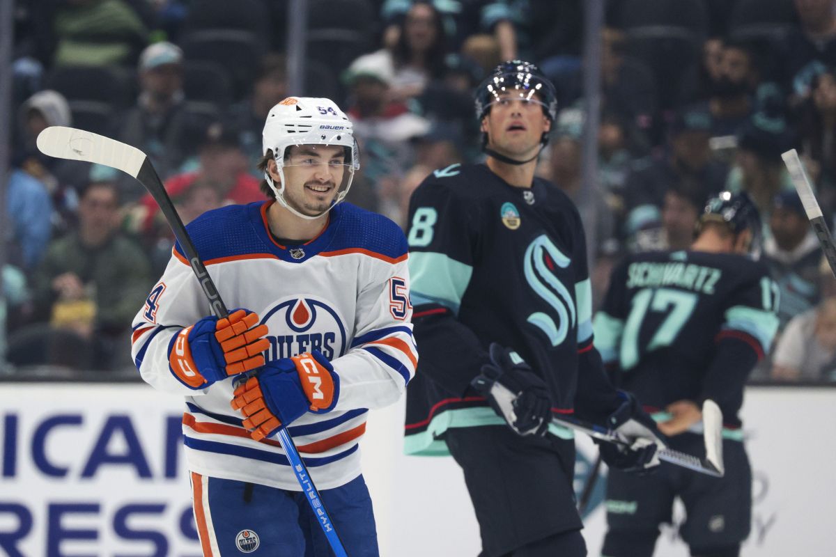 Edmonton Oilers centre Xavier Bourgault (54) reacts after scoring as Seattle Kraken defenceman Cale Fleury (8) skates away during the first period of a preseason NHL hockey game, Monday, Oct. 2, 2023, in Seattle.