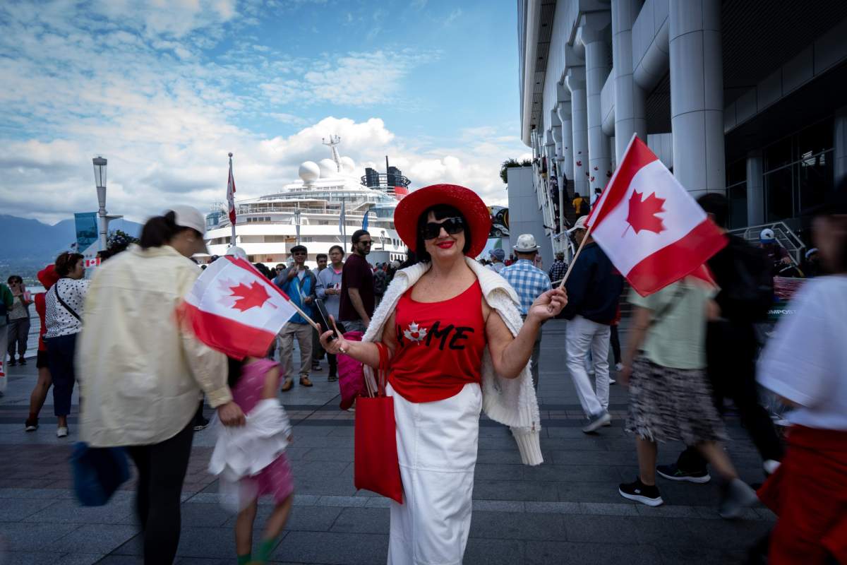 Tatyana Shevchenko from Ukraine celebrates Canada Day in Vancouver, Monday, July 1, 2024. THE CANADIAN PRESS/Ethan Cairns