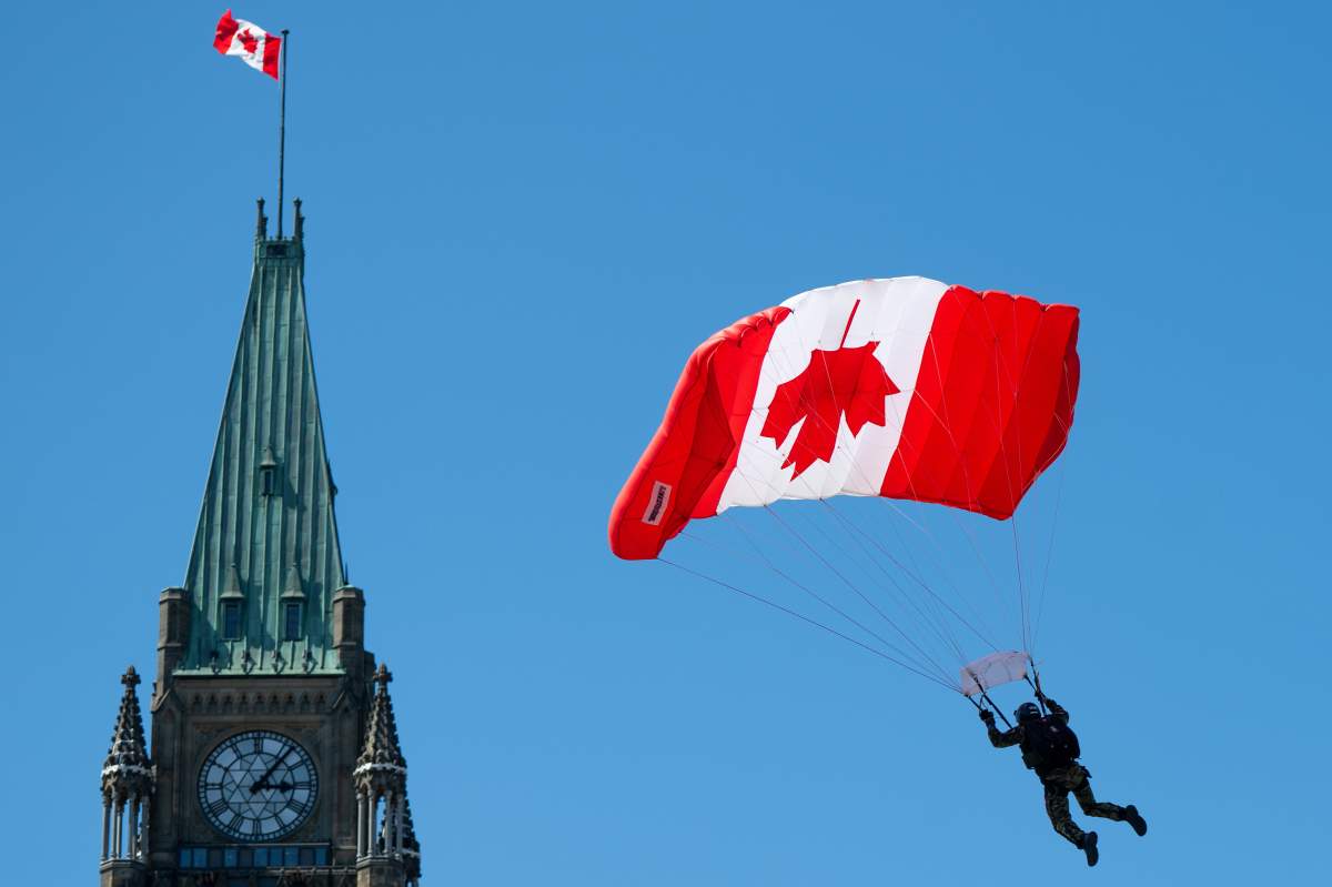 A Canadian Armed Forces (CAF) SkyHawks member comes into landing over Parliament Hill during Canada Day celebrations in Ottawa, on Monday, July 1, 2024. THE CANADIAN PRESS/Spencer Colby
